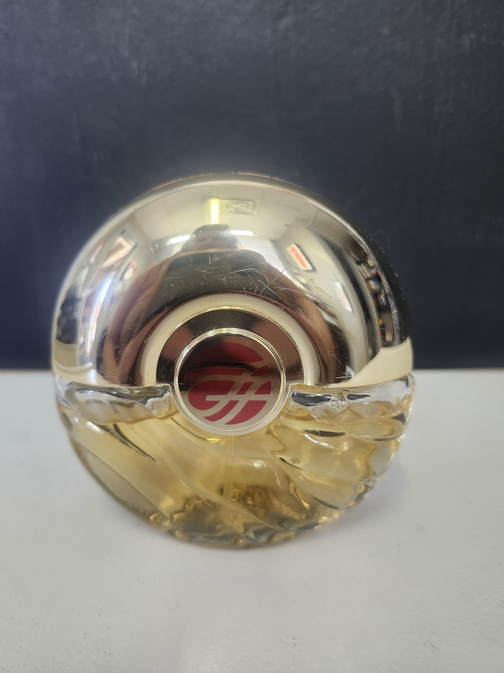 vintage Avon Foxfire cologne featuring a round glass bottle Used
